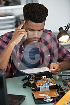 man reading instructions for dismantled device