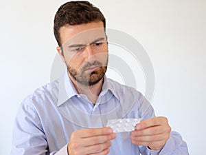 Man reading instructions of a medicine