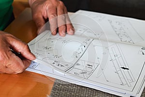 Man reading instructions to assemble furniture