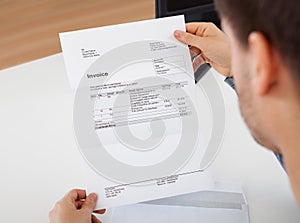 Man reading a invoice document