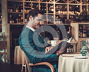 Man reading menu in a restaurant