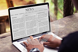 Man reading news article on the laptop / computer screen