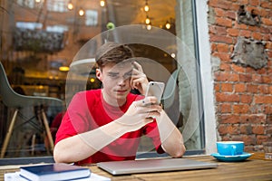 Man reading news in internet via cell telephone