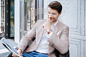 Man reading newspaper outdoor in cafe