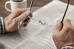 Man reading newspaper on table