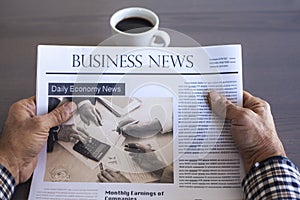 Man reading newspaper on table