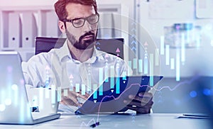 Man reading report in office, growing graph