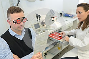 Man reading text while wearing optometrists glasses