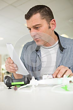 man reading vblog instructions