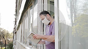 Man reads a book near the window