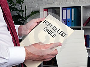 Man reads Debt relief order DRO in the book.
