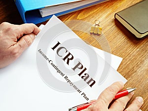 Man reads ICR Income-Contingent Repayment Plan photo