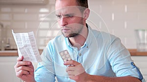 A man reads the instructions for taking pills