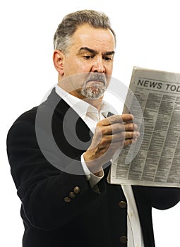 Man reads newspaper with serious look on face