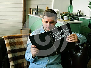 Man reads about personal finances. Financial literacy concept.