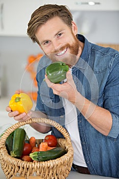 man ready for cutting vegetables in kitchen