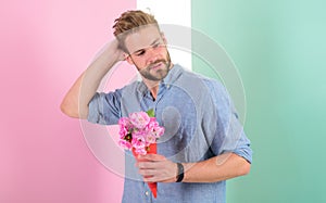 Man ready for date bring pink flowers. Boyfriend confident holds bouquet waiting for date. Guy bring romantic pleasant