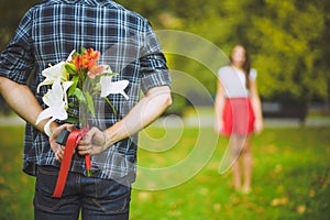 Man ready to give flowers to girlfriend