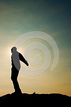 Man ready to jump. Adult crazy man is jumping on colorful sky background.Silhouette of man and beautiful sunset sky.