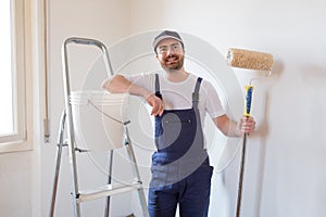Man ready to paint one wall holding painting tools
