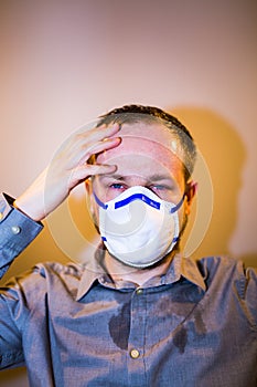 Man with real Coronavirus COVID-19 disease symptoms wears a protective mask