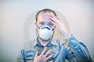 Man with real Coronavirus COVID-19 disease symptoms wears a protective mask