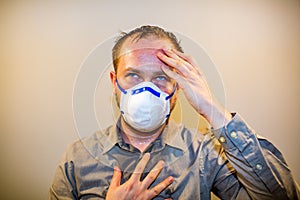 Man with real Coronavirus COVID-19 disease symptoms wears a protective mask