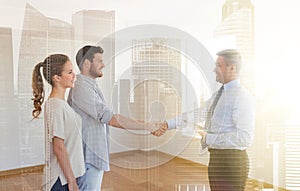 Man and realtor shaking hands at new home