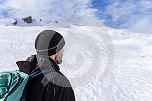 Man in rear view hiking in amazing alpine winter mountains landscape. Haehlekopf, Berlingerskoepfle, Vorarlberg, Austria