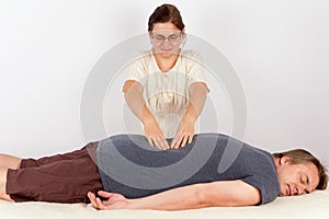 Man receives Bowen therapy similar to back massage photo