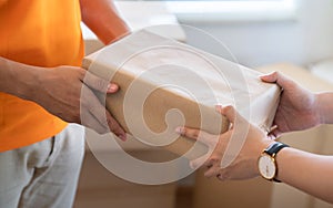 Man receives a package from the courier`s hand.