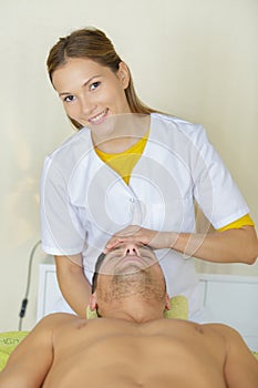 man receiving head massage in medical office