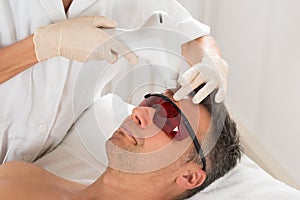 Man Receiving Laser Epilation Treatment