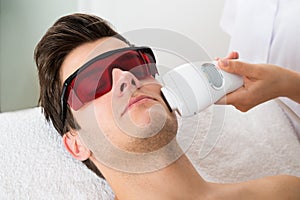 Man Receiving Laser Hair Removal Treatment photo