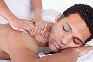 Man receiving massage from female hand