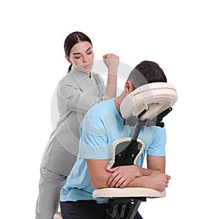 Man receiving massage in modern chair on white background