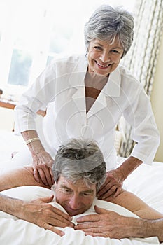 Man receiving a massage from a woman