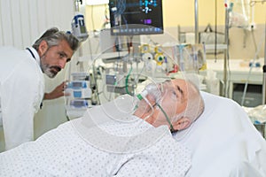 Man receiving oxygen in hospital bed