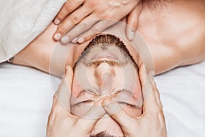 Man receiving relaxing head massage