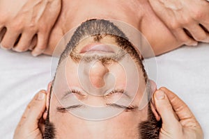 Man receiving relaxing head massage