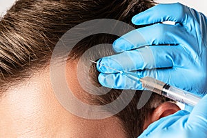 Man receiving scalp injection for hair grow