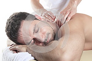 Man receiving Shiatsu massage from a professional