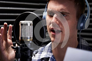 Man In Recording Studio Talking Into Microphone