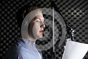 Man In Recording Studio Talking Into Microphone