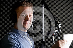 Man In Recording Studio Talking Into Microphone