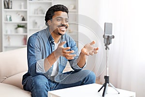 Man recording a video on smartphone at home