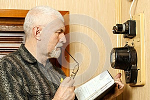 A man records the readings of an electricity meter