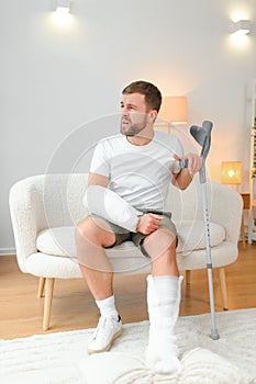 man recovery from accident fracture broken bone injury with leg splints in cast neck splints collar arm splints sling