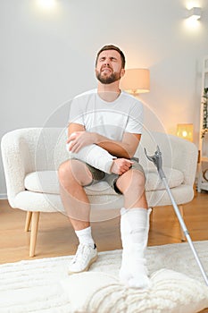 man recovery from accident fracture broken bone injury with leg splints in cast neck splints collar arm splints sling