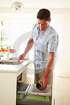 Man Recycling Kitchen Waste In Bin